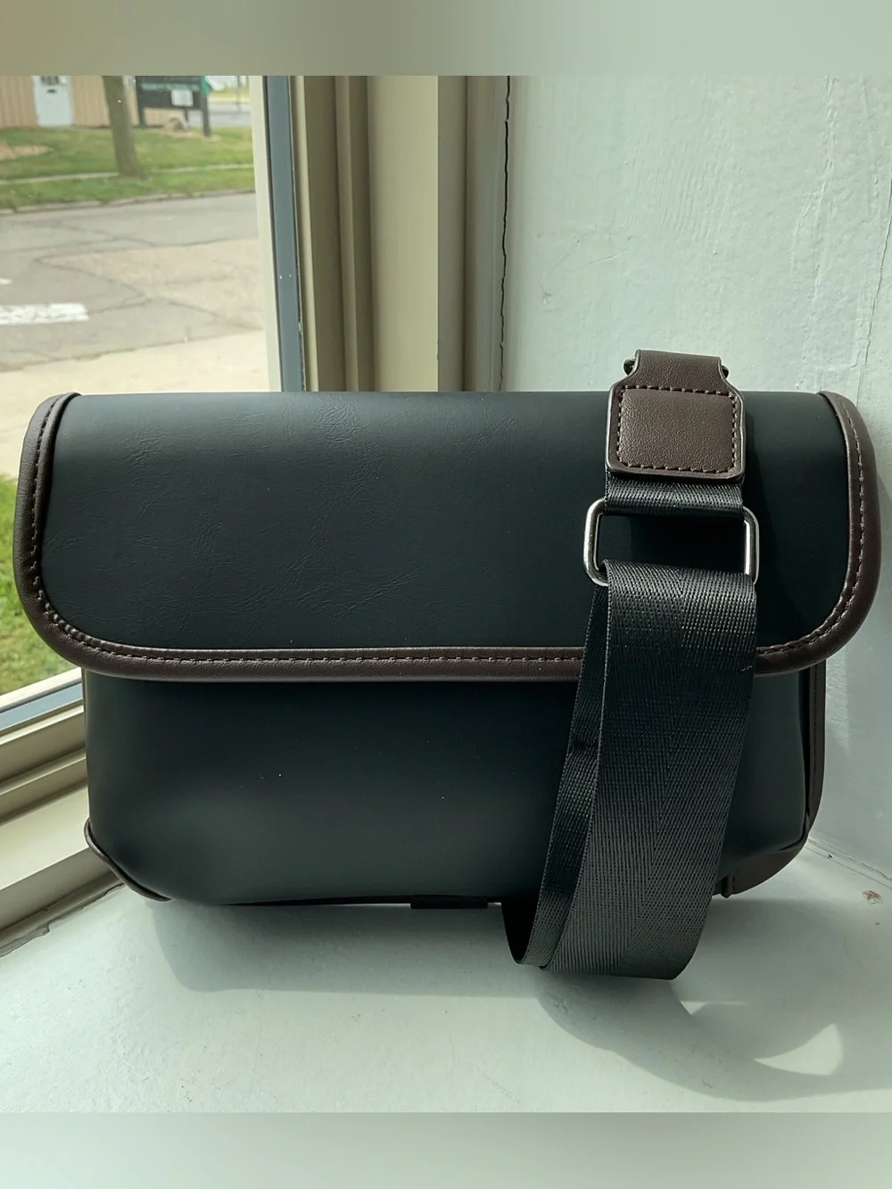 Black Crossbody Bag with Brown Trim and Adjustable Strap